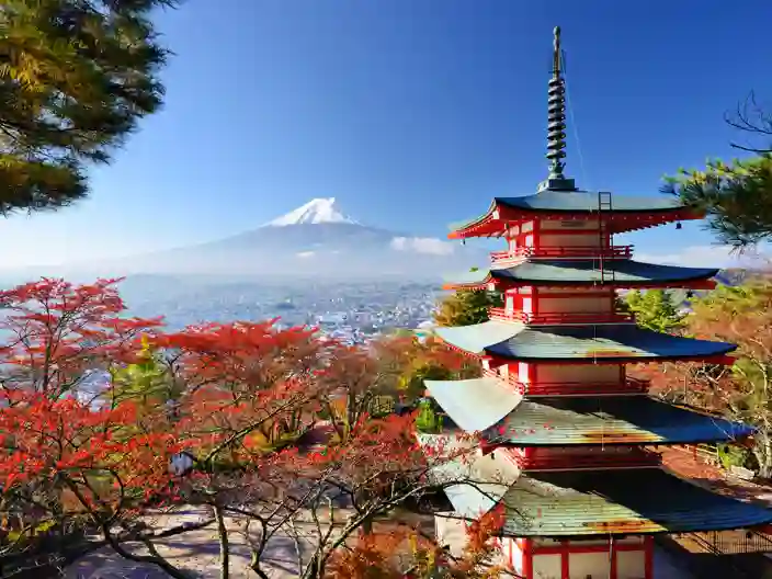 Mount Fuji omges av färgstarka höstlöv i ett klassiskt japanskt landskap.