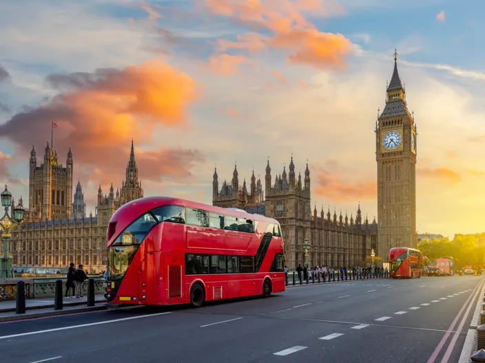 Röd dubbeldäckare på bron vid Big Ben och Westminster Palace